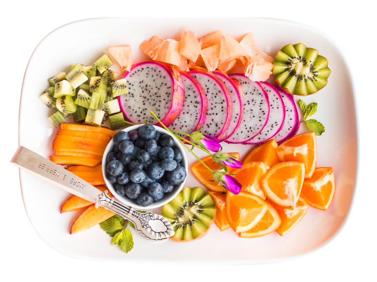 Vibrant tropical fruit platter with dragon fruit and more, shot from above.
