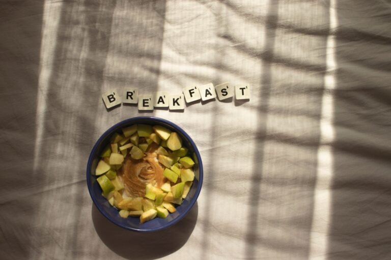 A nutritious breakfast bowl with peanut butter and apples in natural lighting.