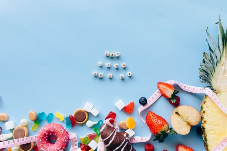 Juxtaposition of sugary sweets and fresh fruits with a message to eat less sugar.
