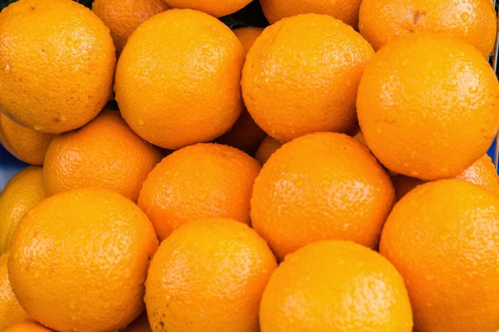 A vibrant close-up of fresh oranges showcasing their natural texture and color.