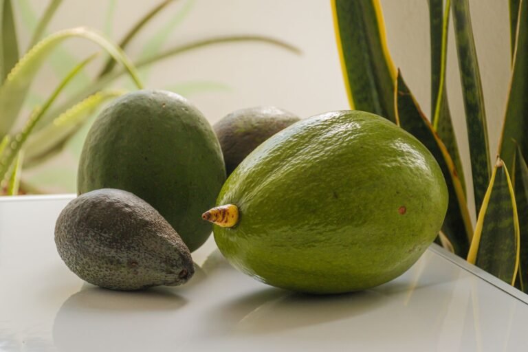 Close-up of ripe avocados on a white surface, perfect for healthy eating visuals.