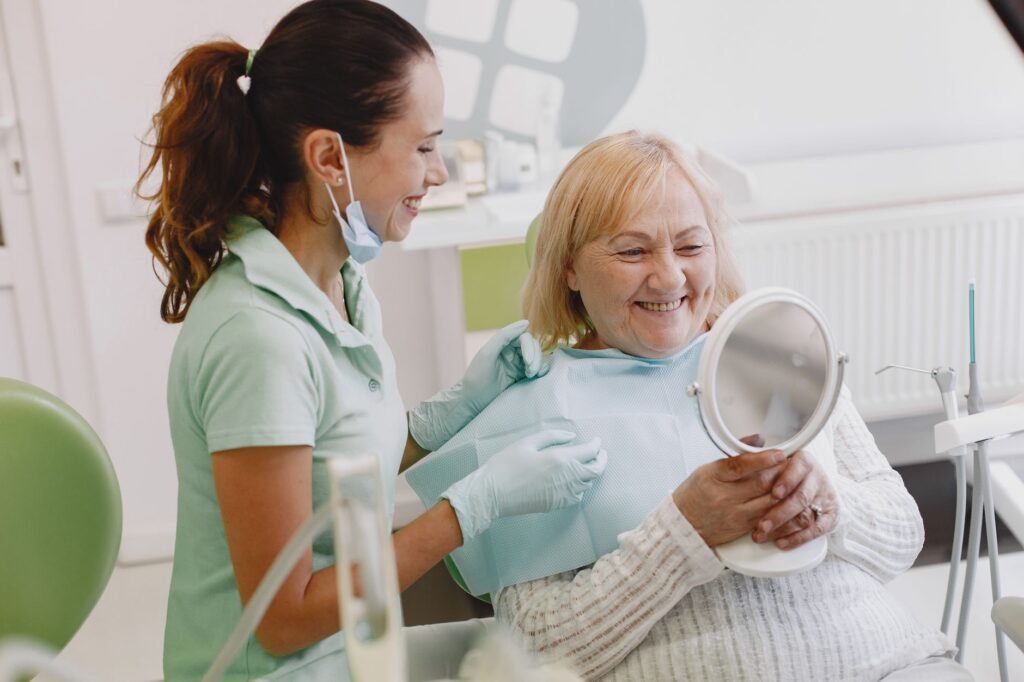 Senior patient at a dental check-up, smiling with the dentist in a modern clinic.