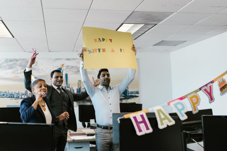 A joyful office birthday celebration with colleagues holding a sign. Perfect for business and lifestyle concepts.
